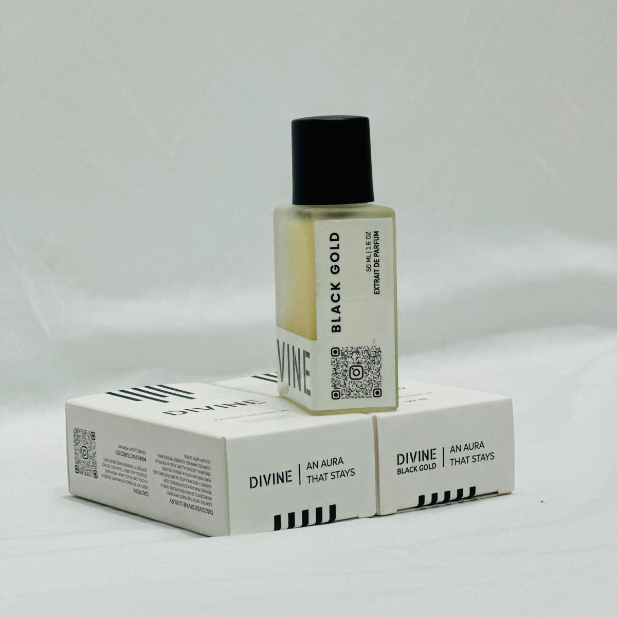 Small bottle with black cap and white label on a white box with similar branding, against a light gray background.