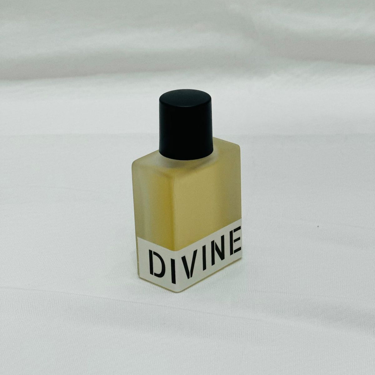 Small bottle labeled 'DIVINE' on a white background